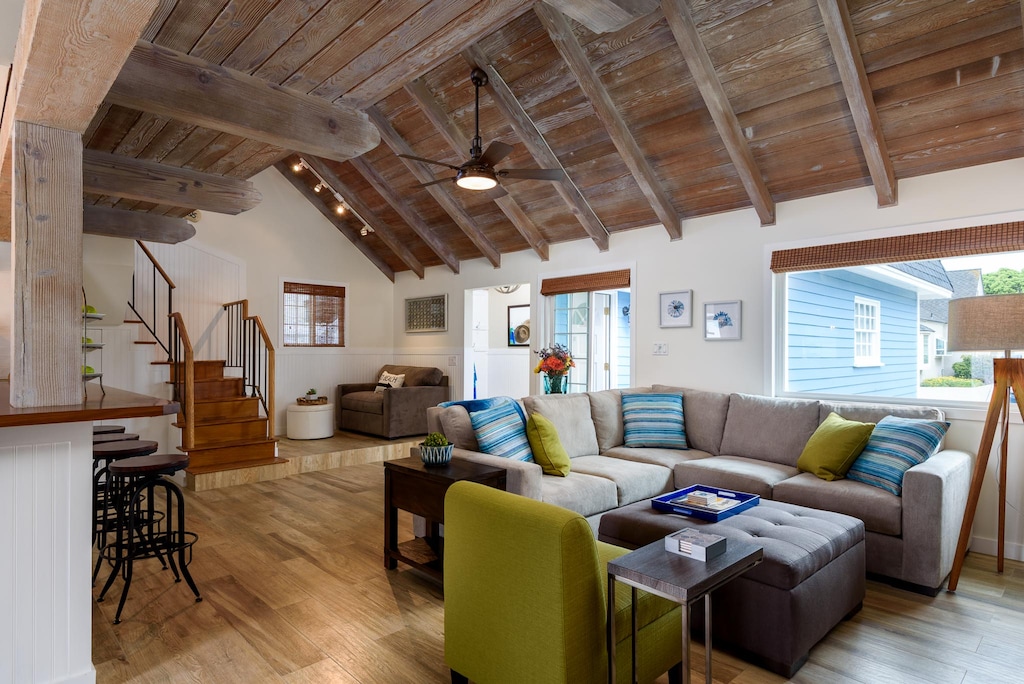 Living Room looking out to front of house. Twin sofa sleeper near the stairs.