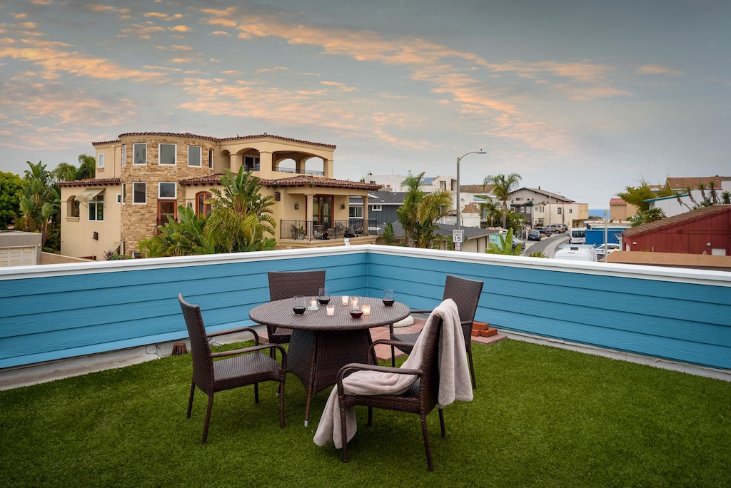 Rooftop patio deck with a sunset view and peak of the ocean