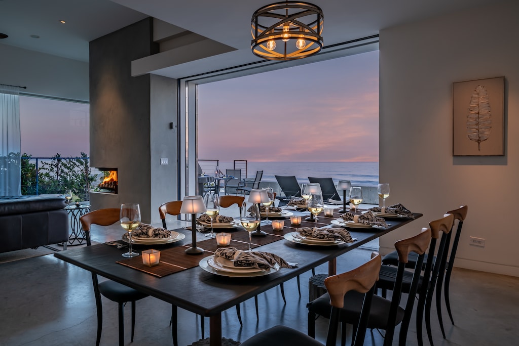 Living Room with panoramic ocean views~ a fireplace~ and a TV.