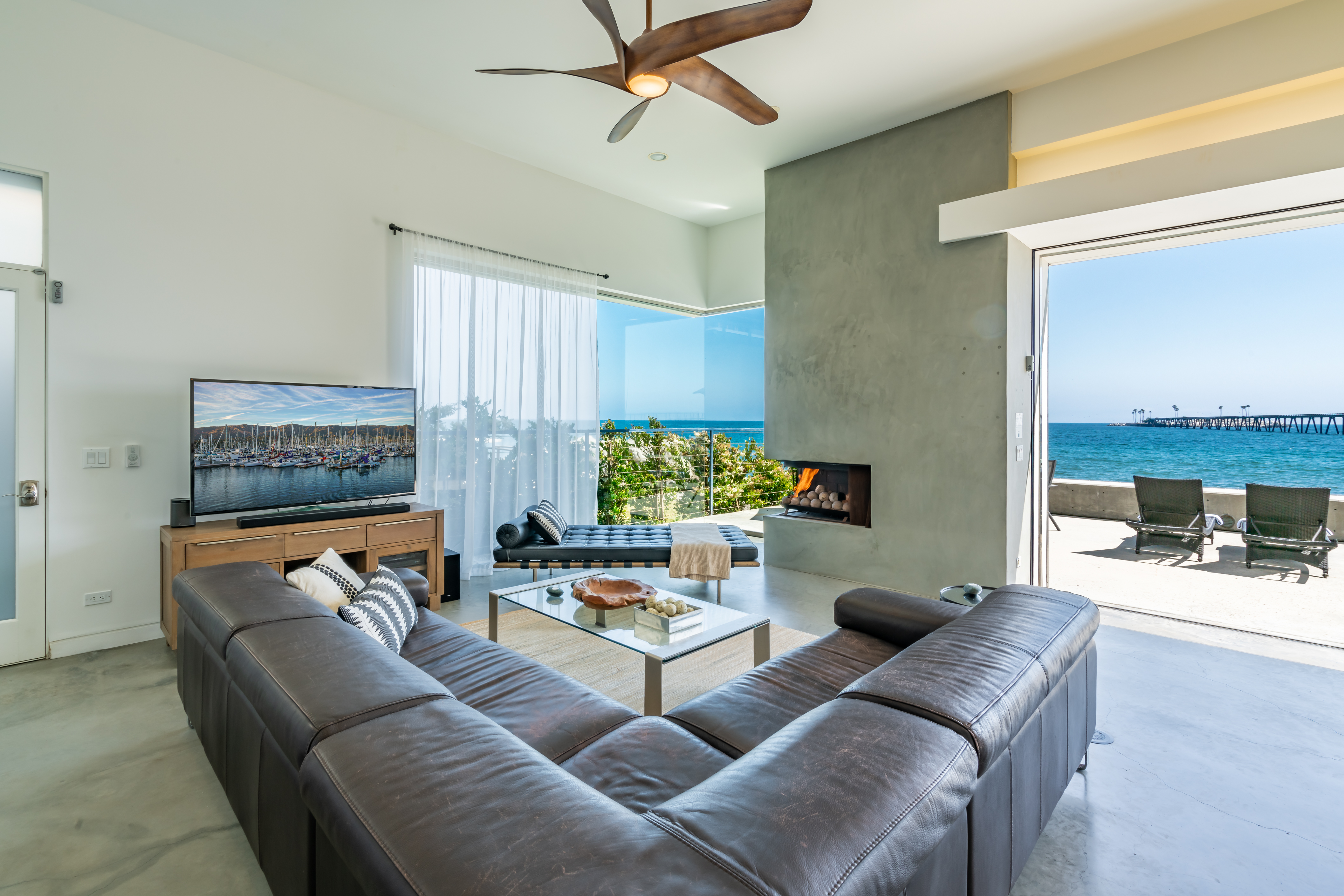 Living Room with panoramic ocean views~ a fireplace~ and a TV.