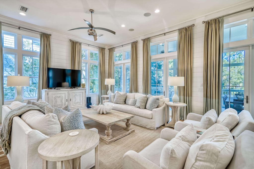 Main living room with large TV and lots of plush seating