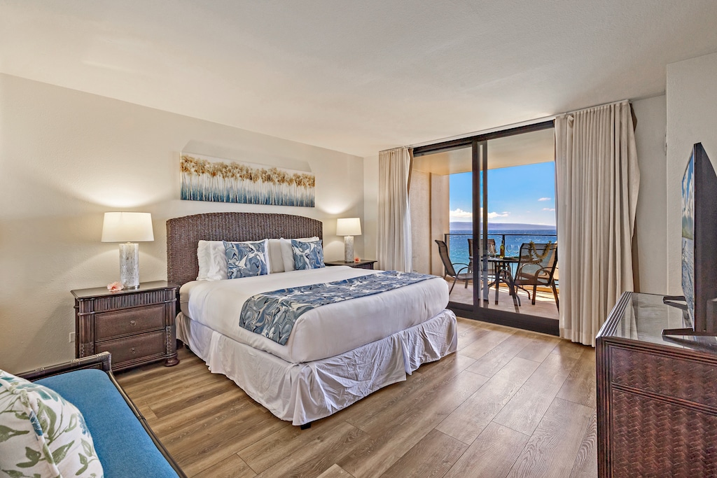 Wake to ocean views from the king bed and lanai at Mahana 718.