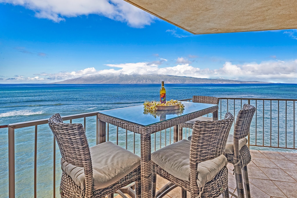 Spacious Royal Kahana 1010 lanai with ocean views, perfect for lounging or dining outdoors.