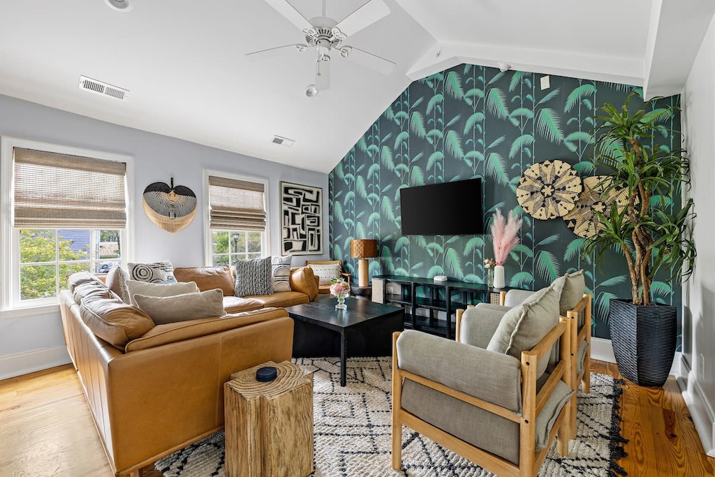 The house is made up of 4 total units. Every unit is made up of 2 bedrooms, 1 bath, kitchen, living room with a washer/dryer! This is living room #1! 