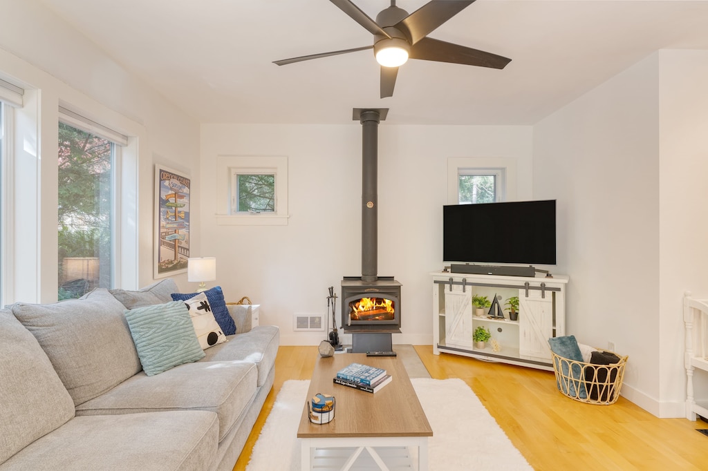Bright and chic living room featuring a fireplace and a TV.