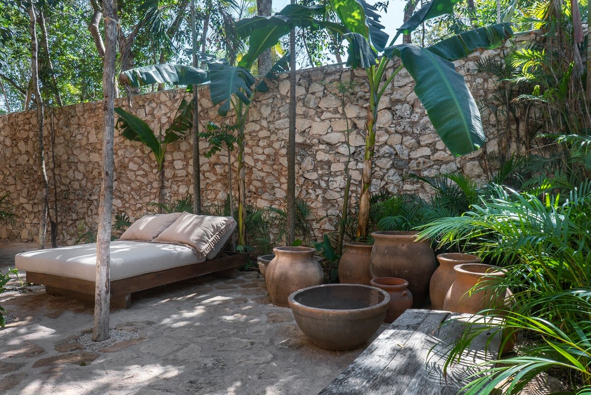 Private patio with outdoor dining area and sun chair..