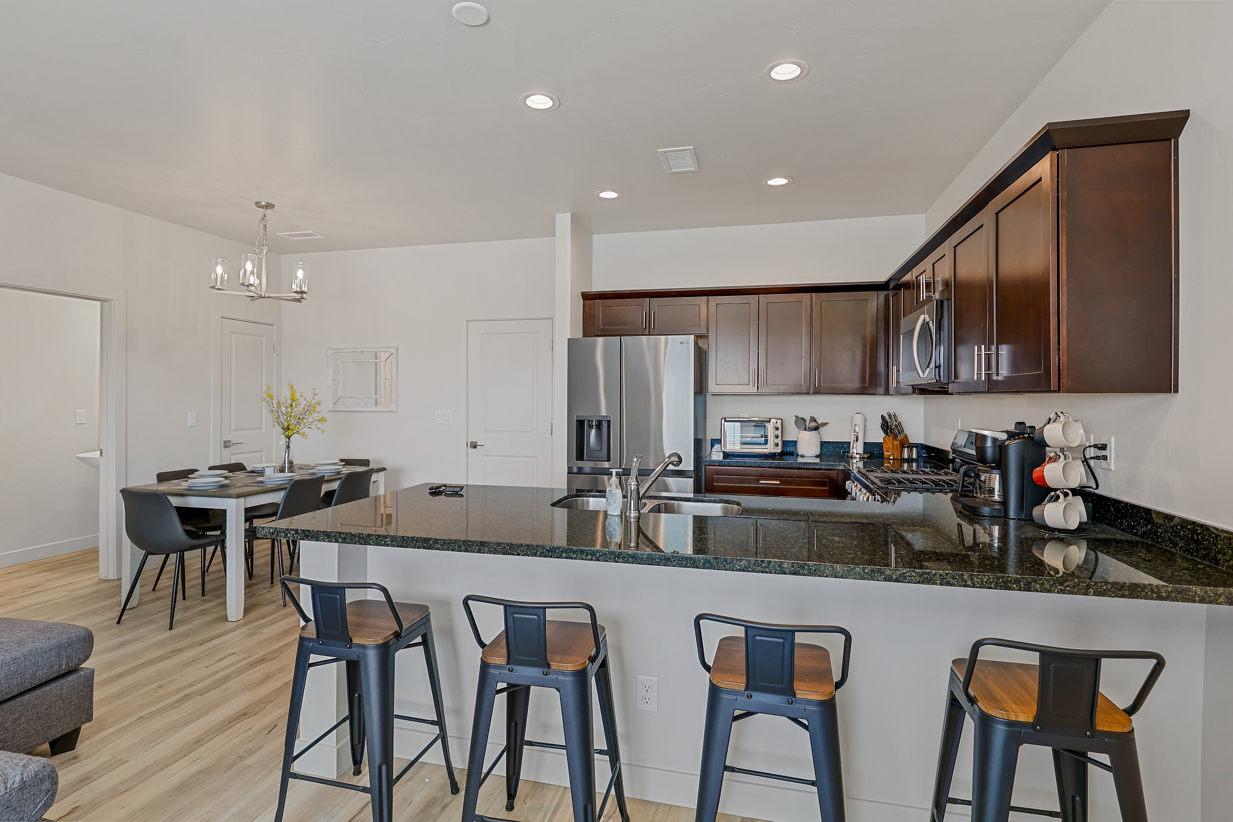 An expansive kitchen welcomes four at the bar to spend time together cooking and hanging out over a cup of coffee. An expansive kitchen welcomes four at the bar to spend time together cooking and hanging out over a cup of coffee.