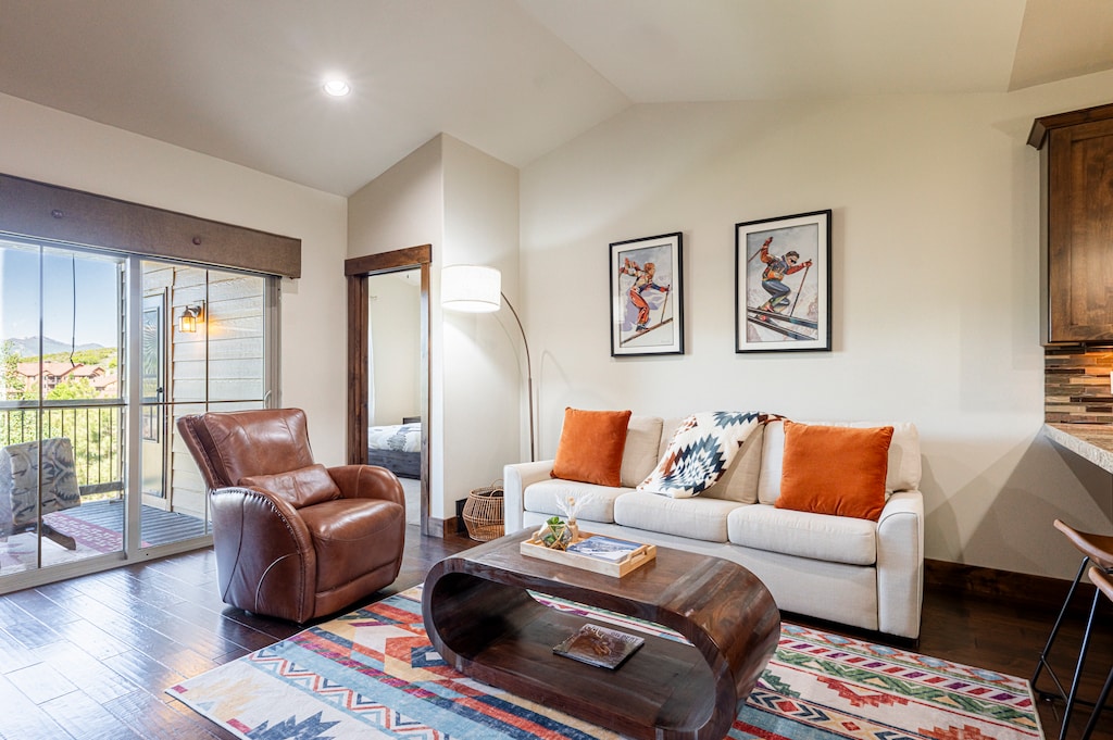 Main level living room with a vaulted ceiling