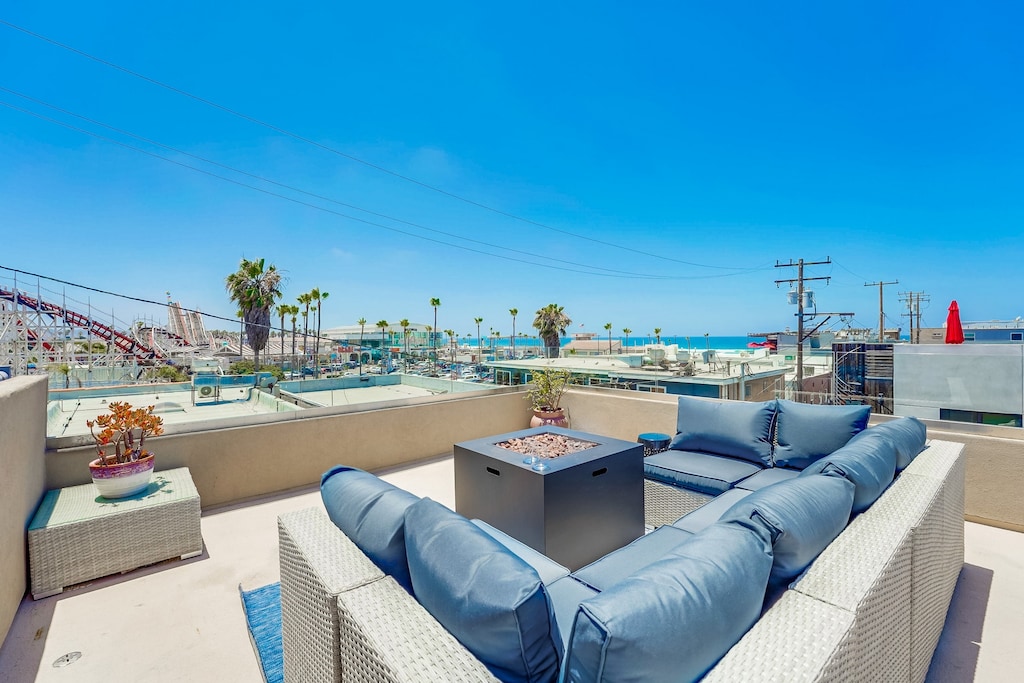 Firepit and couch on rooftop deck