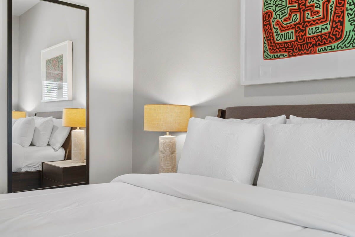 The second bedroom has a queen bed, flat screen TV and blackout curtains.