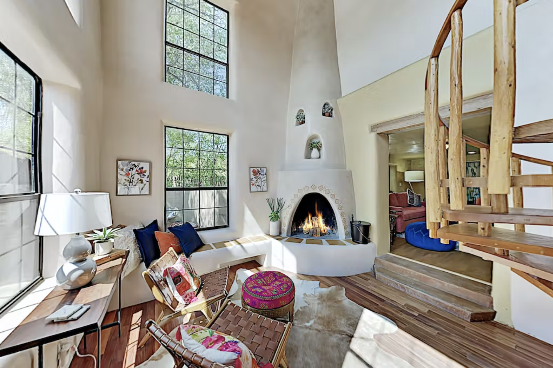 A room with a fireplace and a staircase.