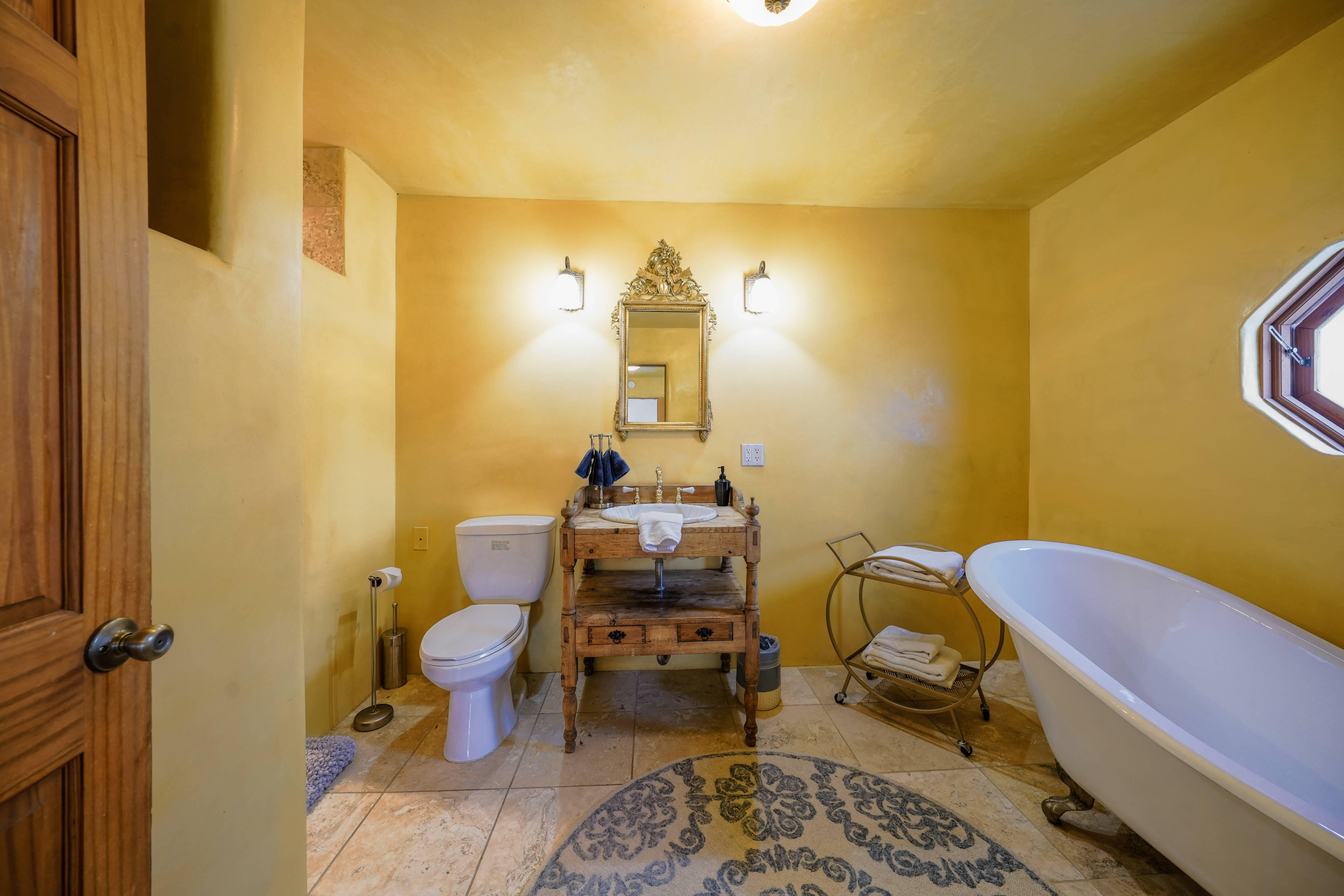 A bathroom with yellow walls and a bathtub.