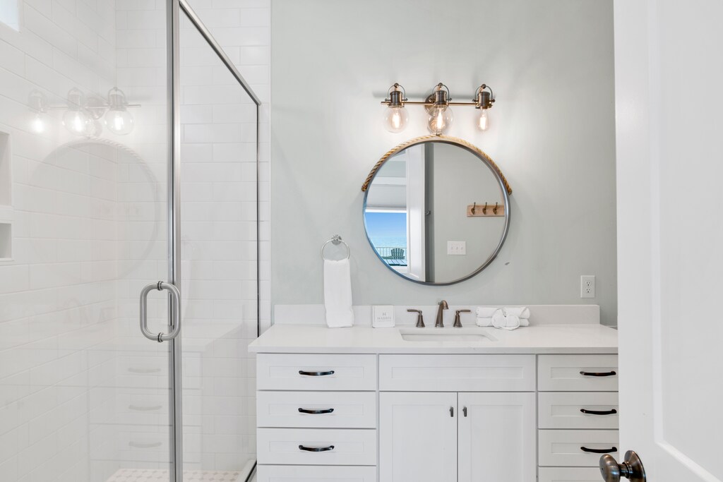 The master bathroom features a walk-in, tile shower