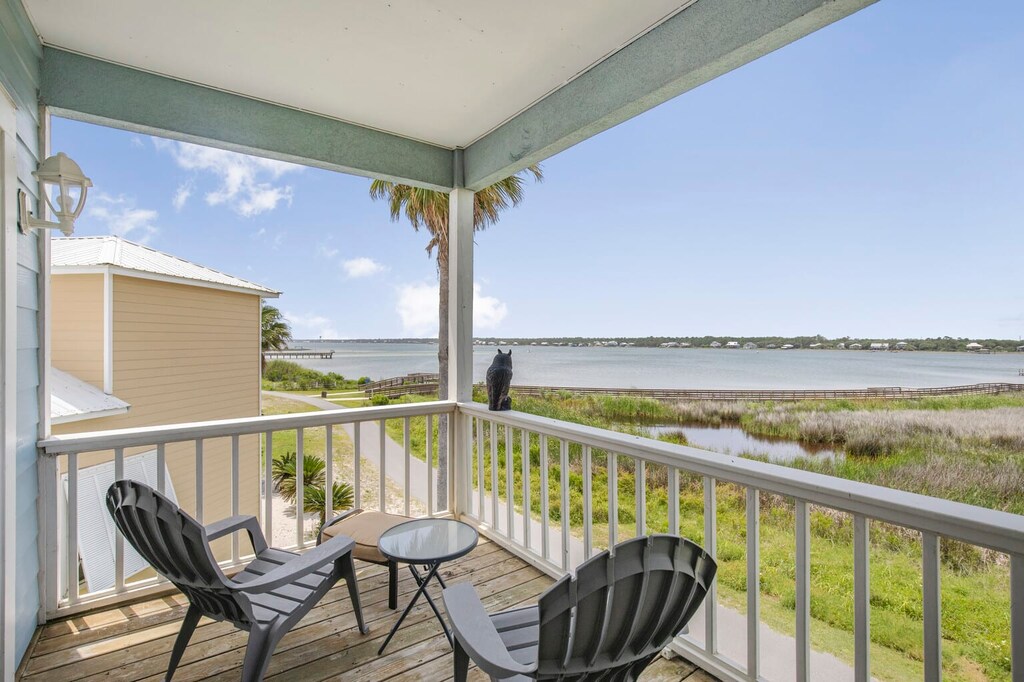 Balcony off the primary bedroom overlooking the walking path & lagoon