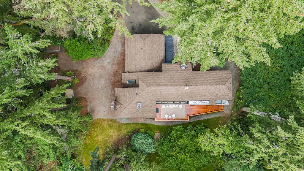An aerial view of our tranquil retreat, nestled beautifully among towering trees and nature’s embrace.