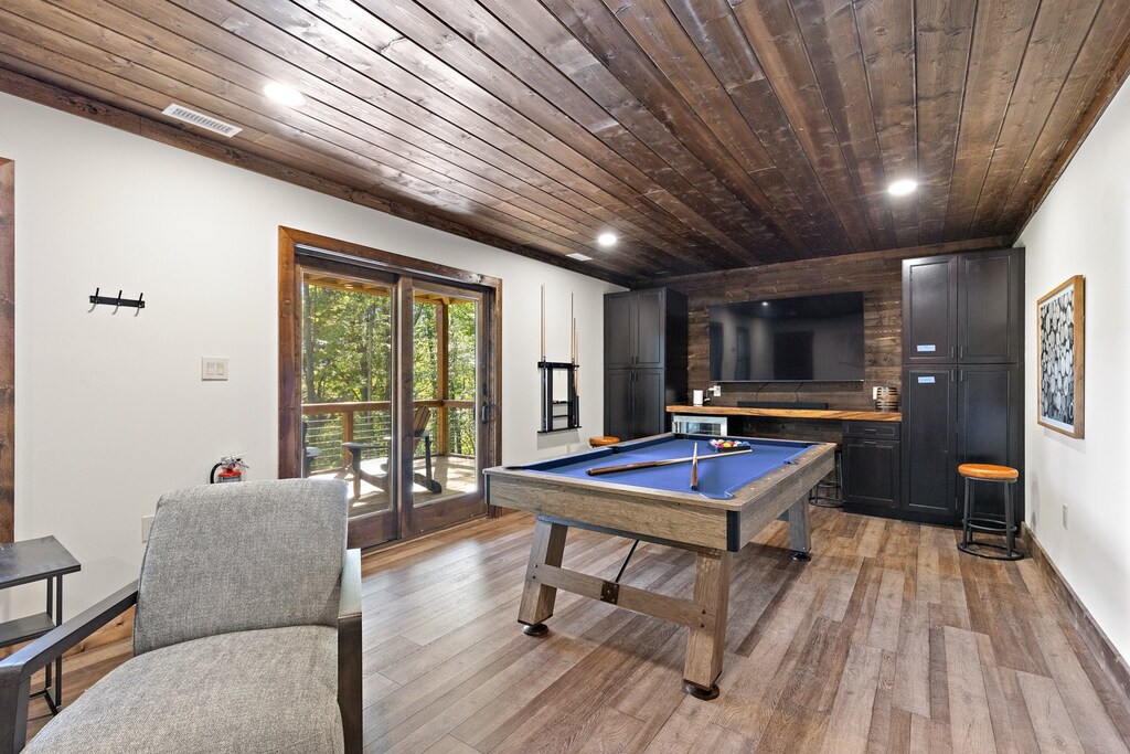 Lower Level Game Room with a Pool Table, Mounted Flat Screen TV and Wet Bar