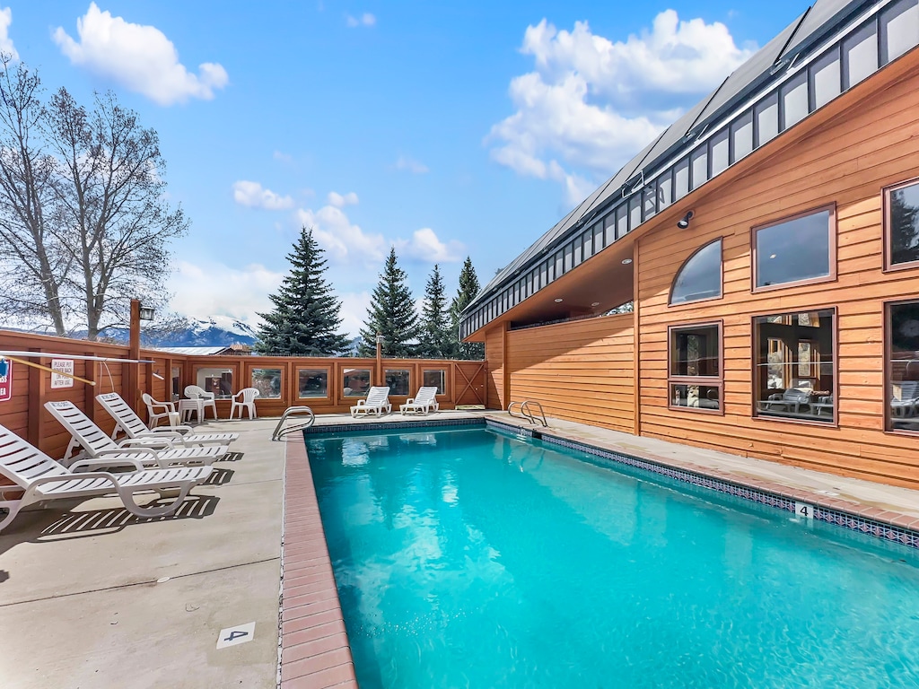 Outdoor swimming pool with lounge chairs at the communal clubhouse.