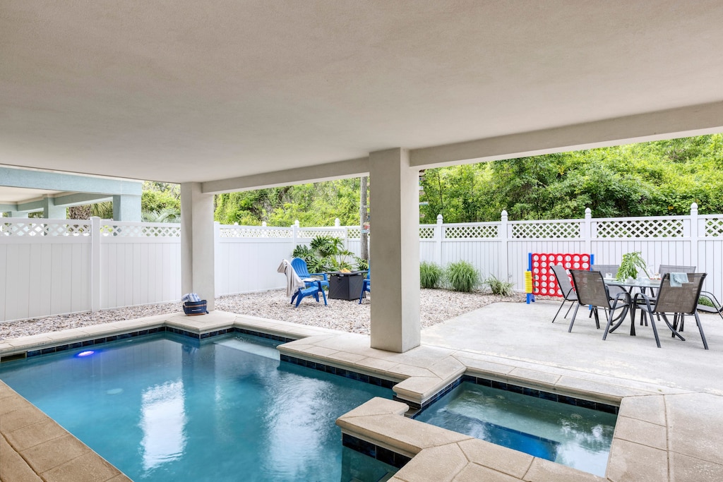 Private yard with pool, hot tub, firepit, and al fresco dining.