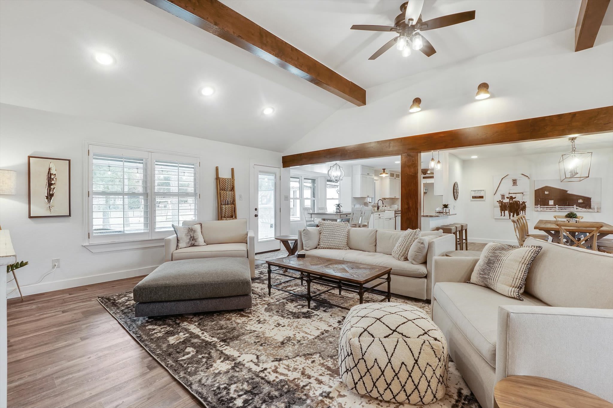 Featuring overhead wooden beams and an arched ceiling, this spacious rustic living room is a place where everyone can feel relaxed and comfortable!