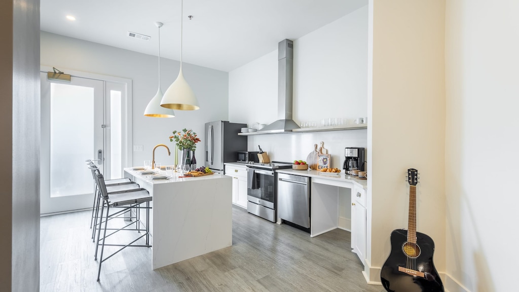 Fully equipped kitchen with a large island and barstool seating.