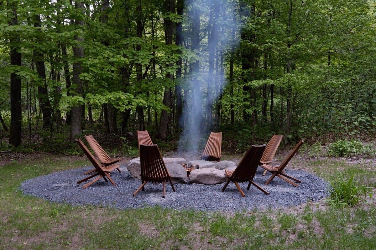 Enjoy cozy bonfire nights and stargazing by the stone bordered fire pit, surrounded by 8 chairs to accommodate the whole group.