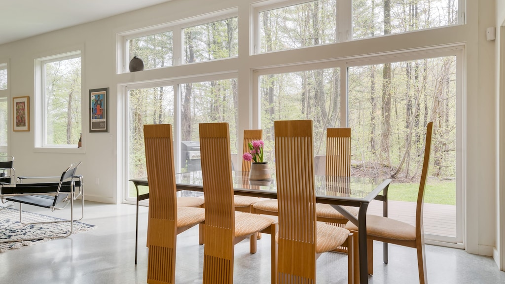 Stylish dining area next to windows overlooking the patio.