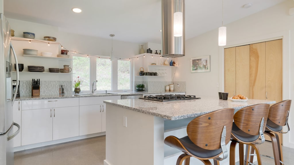Ample counter space and additional barstool seating in the kitchen.