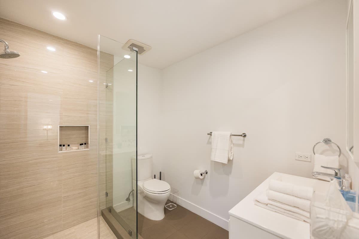 Indulge in luxury in the beautifully appointed bathroom, complete with a shower and all the essential amenities for a comfortable stay.