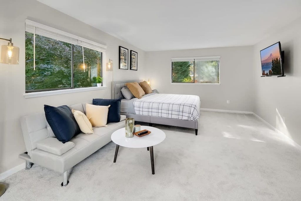Our king-size bed with loveseat setting makes you feel like staying in a high-end hotel! This is the big bedroom on the 2nd floor.