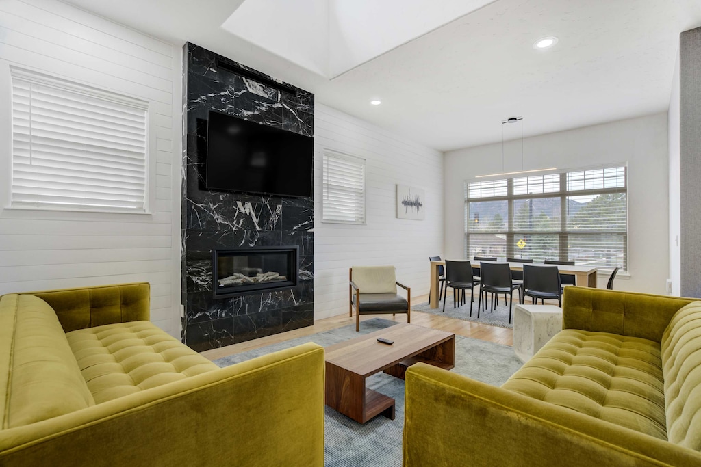 Welcome to Vista Montana! Our modern retreat in Historic Downtown Monument, your perfect getaway! Enjoy our inviting living room with large windows, a sleek modern fireplace, and cozy seating for relaxation.