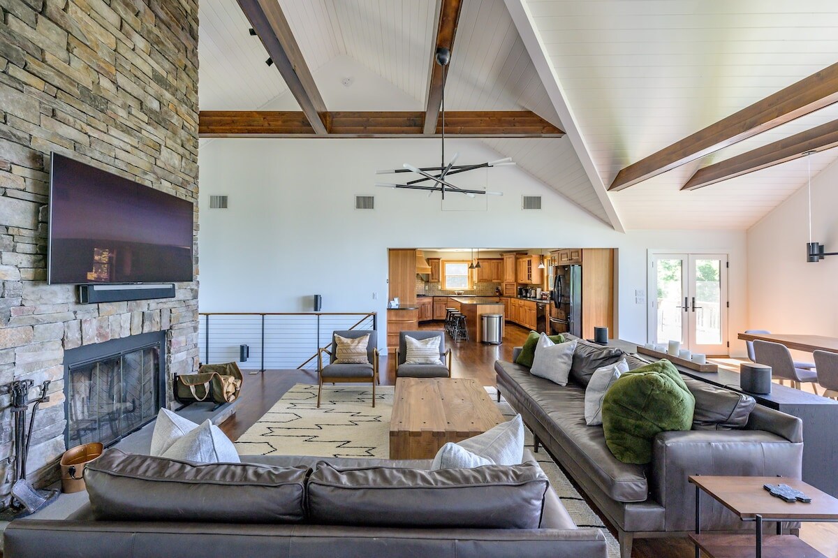 Cozy, ski-lodge-style great room is perfect for entertaining, with high ceilings and fireplace