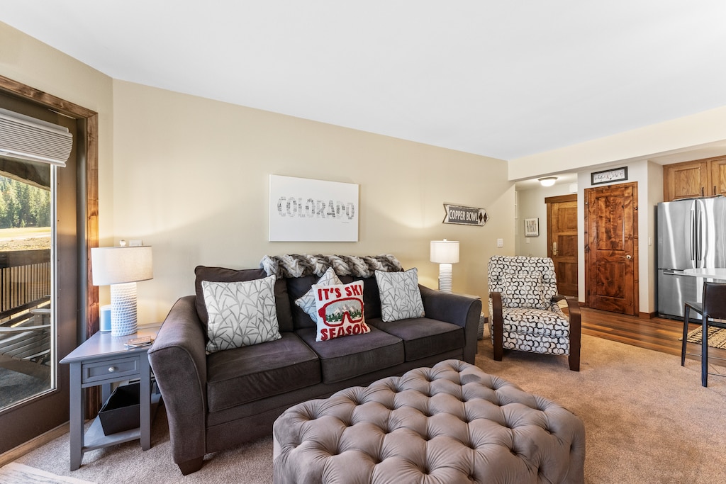 Living area featuring a queen size sleeper sofa, gas fireplace, and flat-screen TV