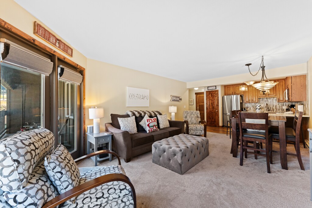 Living area featuring a queen size sleeper sofa, gas fireplace, and flat-screen TV