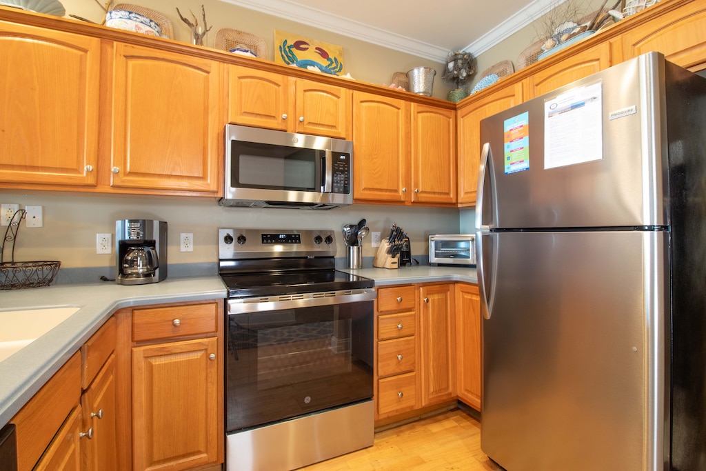 Your fully equipped kitchen awaits with stainless steel appliances, warm wood cabinets, and everything you need to create memorable meals during your stay.