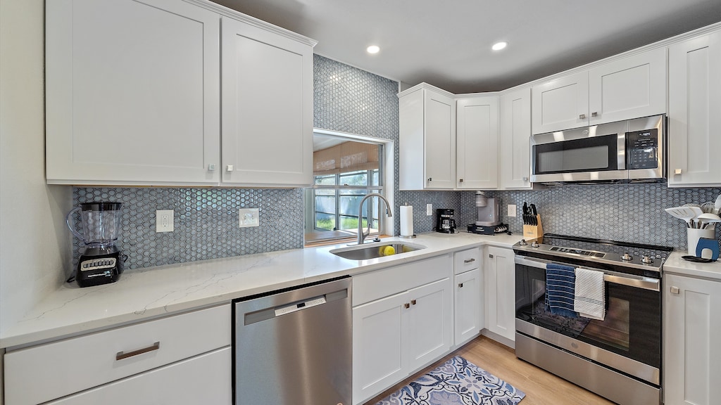 Prepare gourmet meals in this stunning, fully-equipped coastal kitchen with new stainless steel appliances and beautiful quartz countertops overlooking the private backyard oasis.