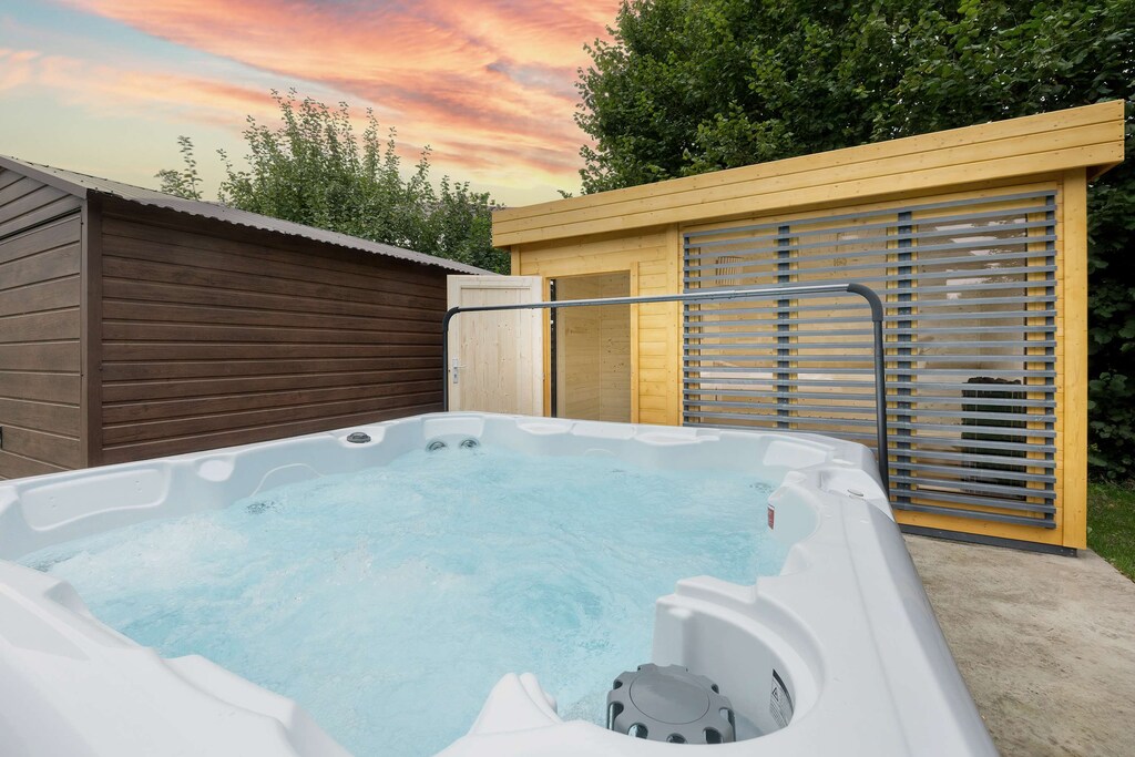 A private hot tub in the garden offers relaxation in warm water at any time of day, with a view of the sunset.
