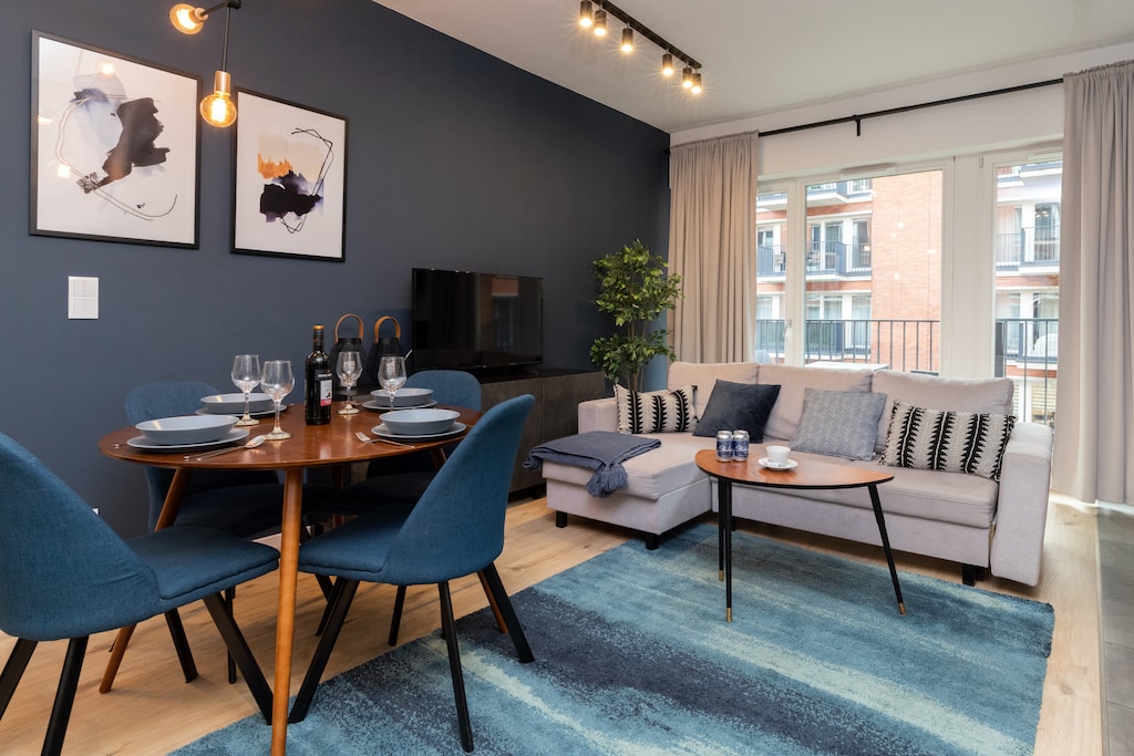 The elegant living room featuring a double sofa bed.