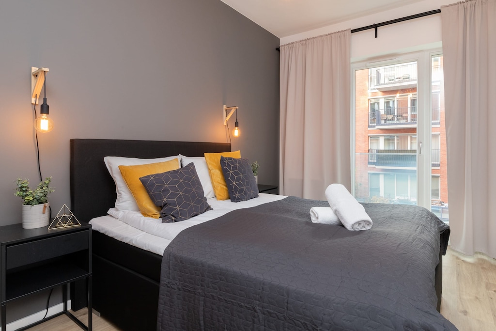The cosy bedroom features a luxurious double bed and ample storage.