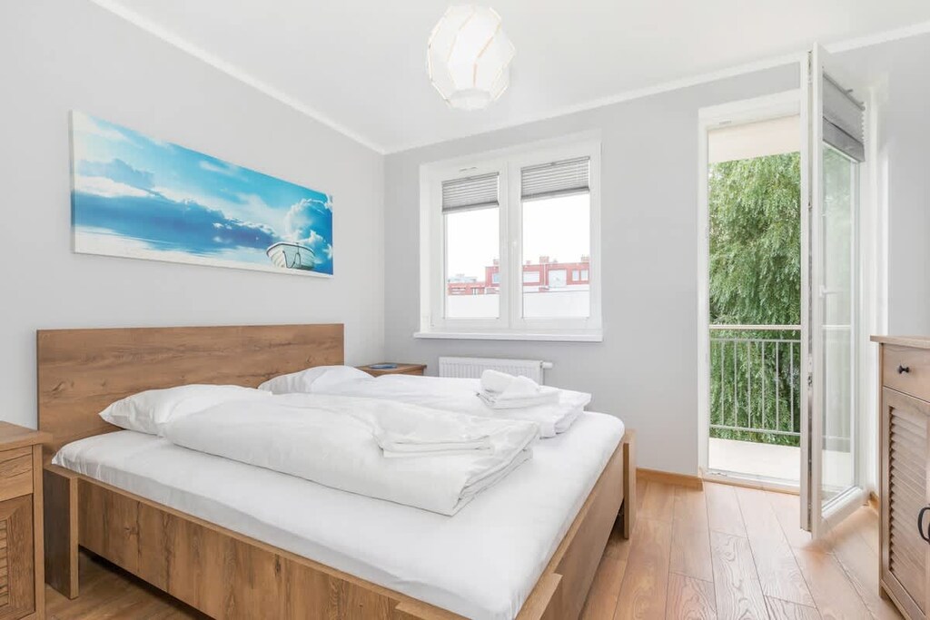 Bedroom with a comfortable double bed and access to balcony.