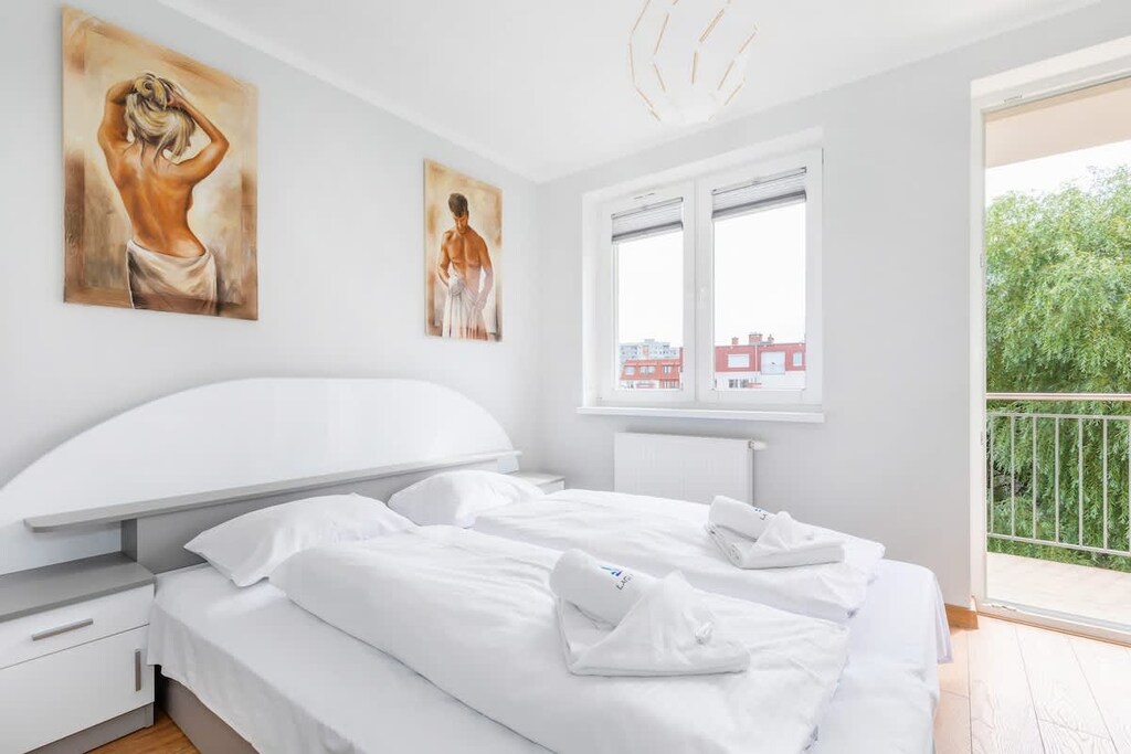 Bedroom with a comfortable double bed and access to balcony.