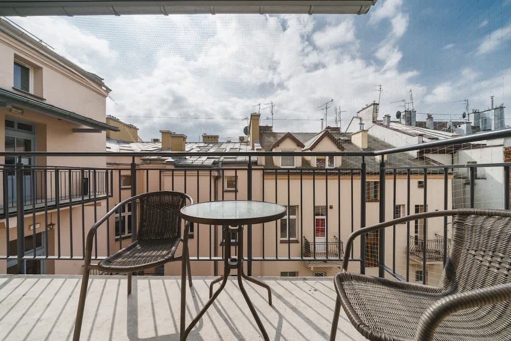 Spacious balcony with outdoor furniture. 