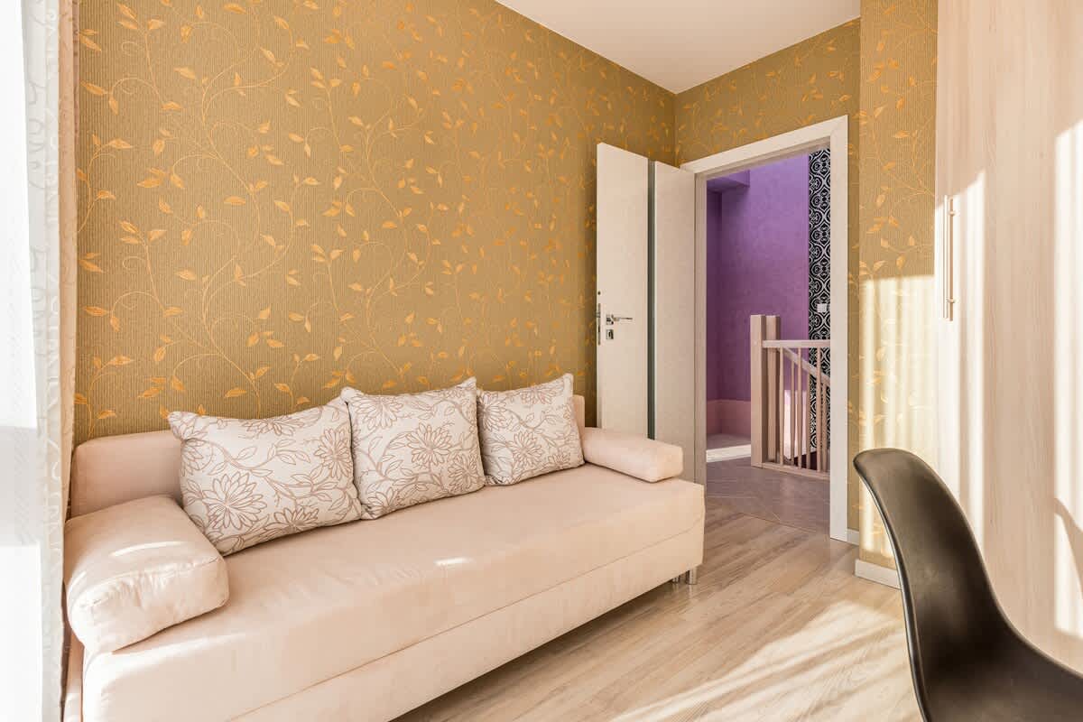 Comfortable, fold-out sofa in the bedroom.