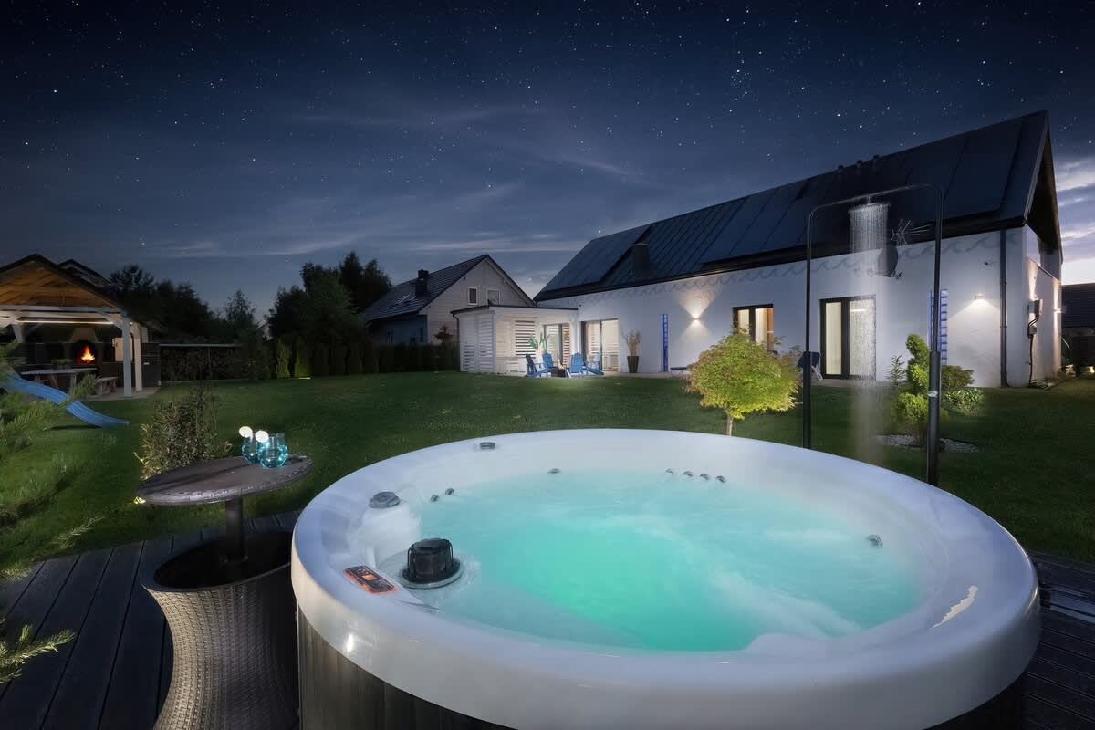 An outdoor shot of a jacuzzi under the night sky, offering a relaxing ambiance.