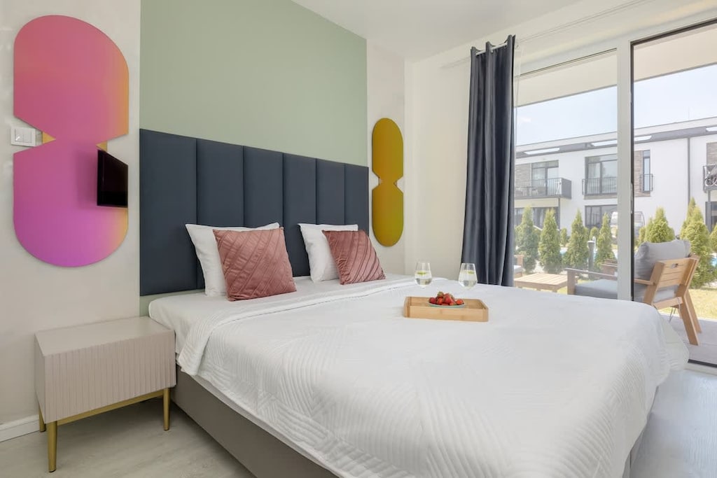 Bedroom with comfortable double bed and television.