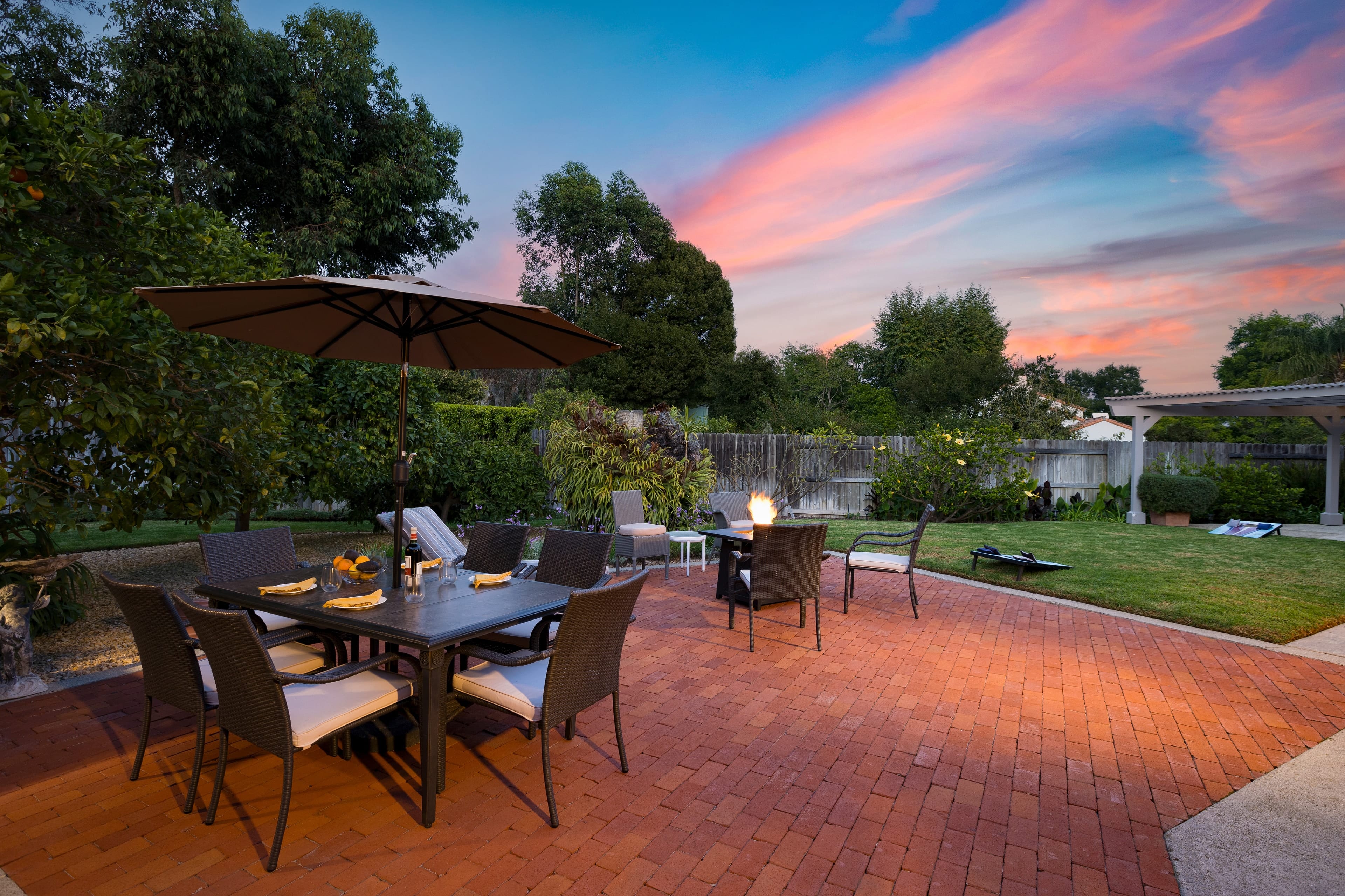 Backyard with a large patio, grill, and plenty of outdoor seating.