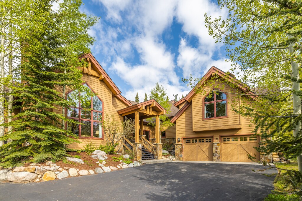 Exterior of the home, featuring a large driveway and oversized garage.