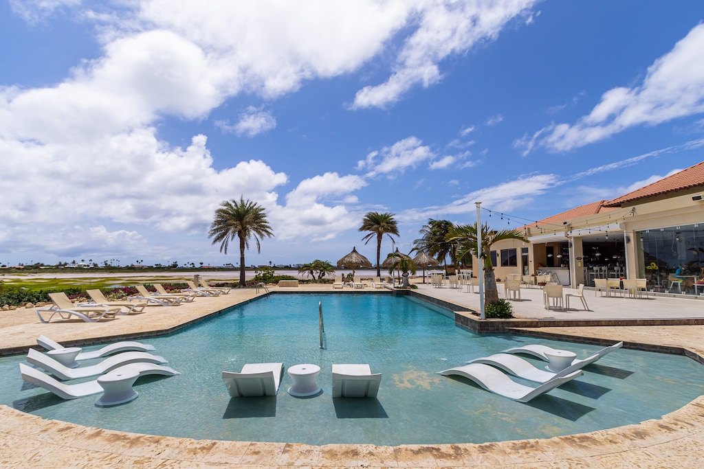 - Enjoy a dip in our resort's shared pool area in Noord, Aruba - A perfect spot for cooling off and unwinding - Lounge by the poolside and soak up the sun with the convenience of cozy beach chairs - Our resort's pool is designed for ultimate leisure