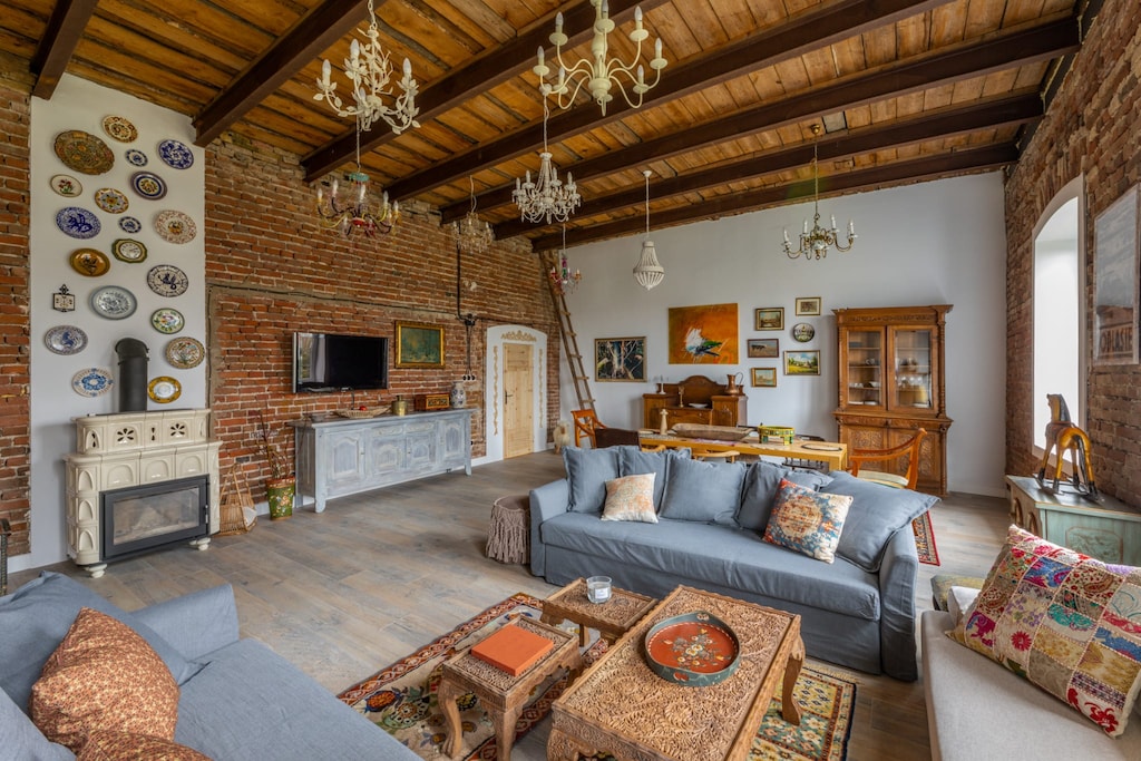 A rustic-style living area with exposed brick walls, wooden beams, and vintage furnishings, creating a cozy and warm atmosphere.