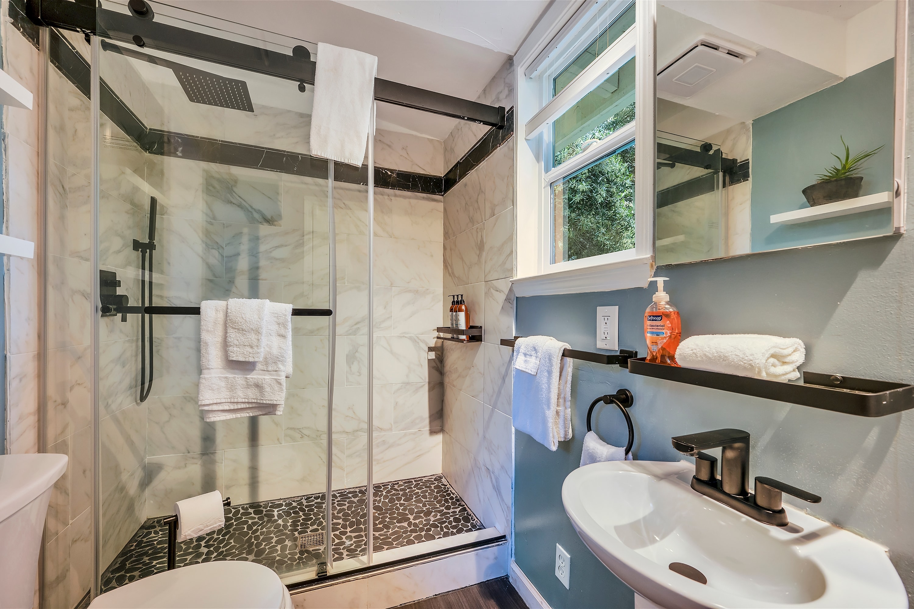Primary bedroom's ensuite bathroom offers a shower.