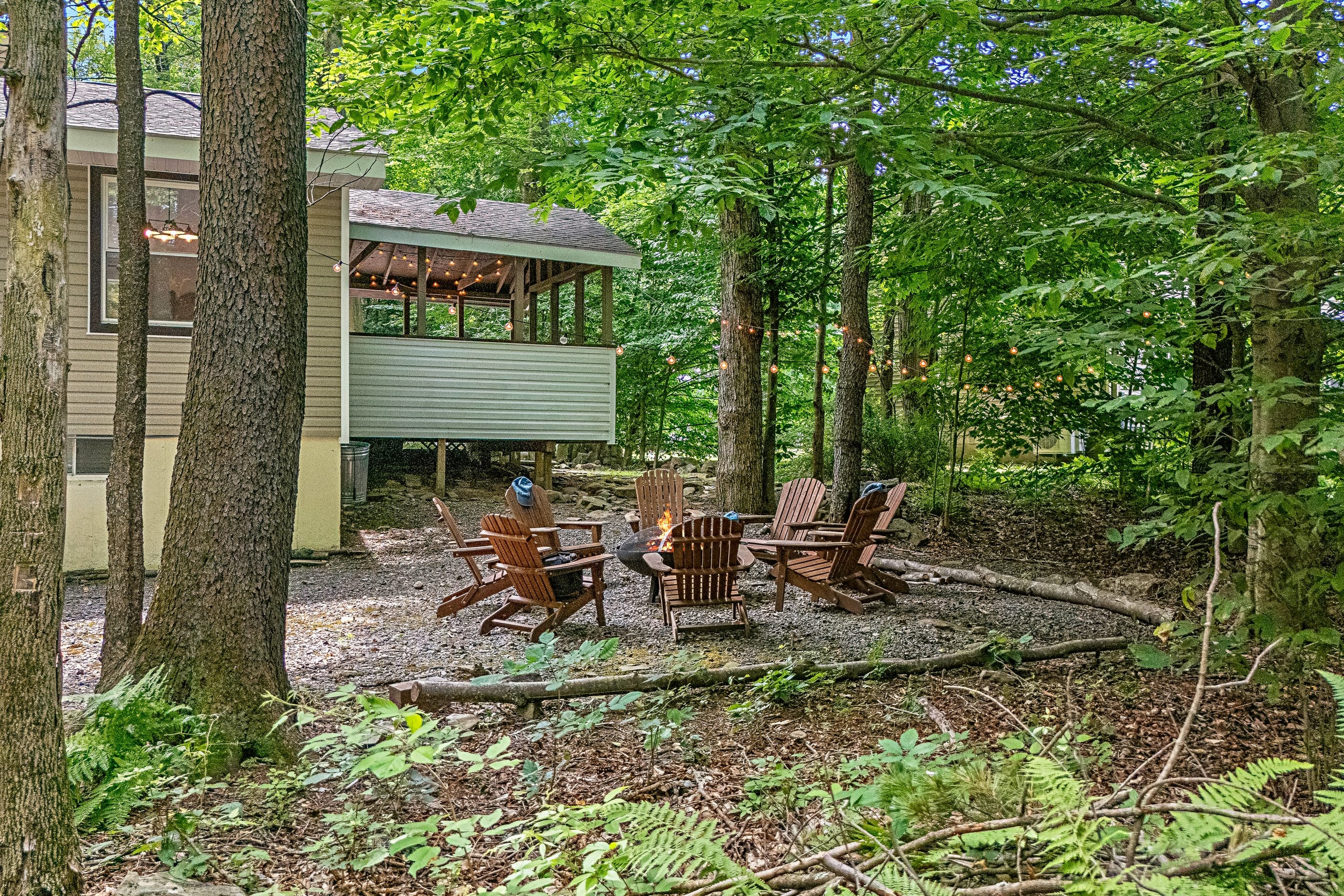 Surrounded by trees with an outdoor firepit.